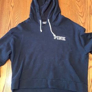 Pink cropped black hoodie.